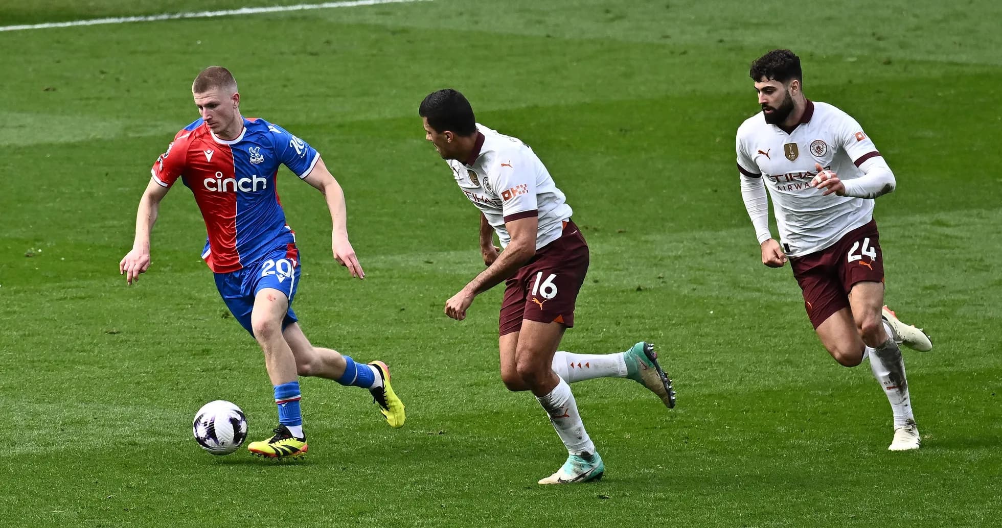 Player dribbling the ball with defenders pursuing