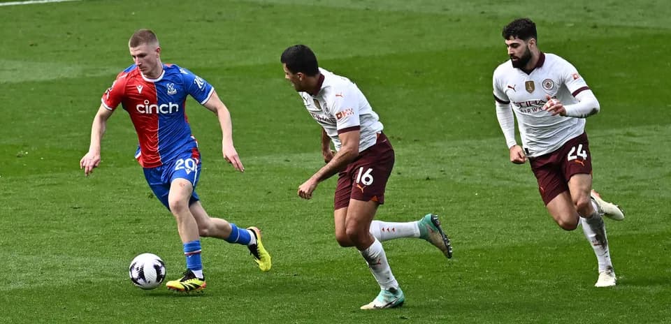 Player dribbling the ball with defenders pursuing