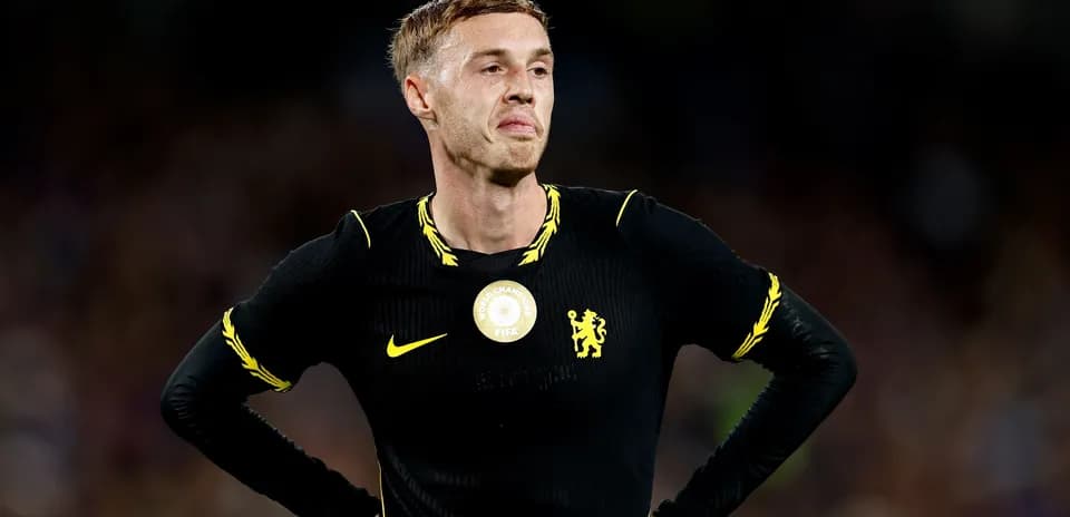 Player in black kit standing with hands on hips