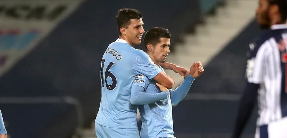 Two players celebrating a goal on the pitch