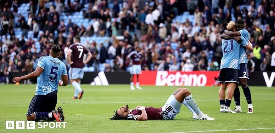 Players reacting after match, one on ground