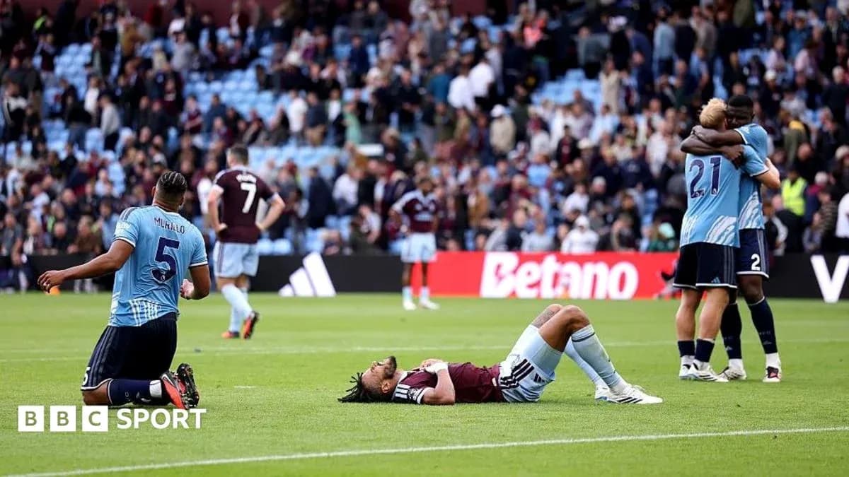 Players reacting after match, one on ground