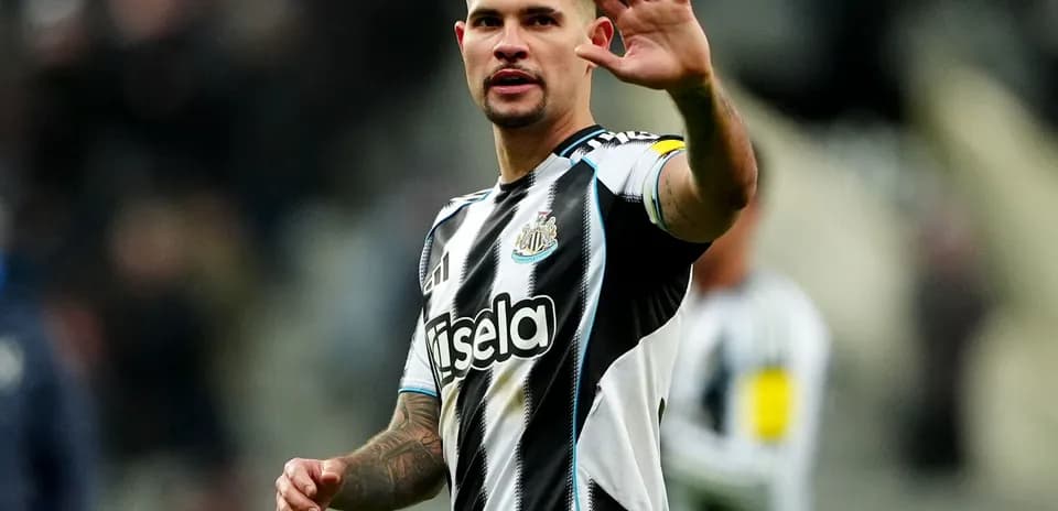 Player waving to fans during Newcastle match