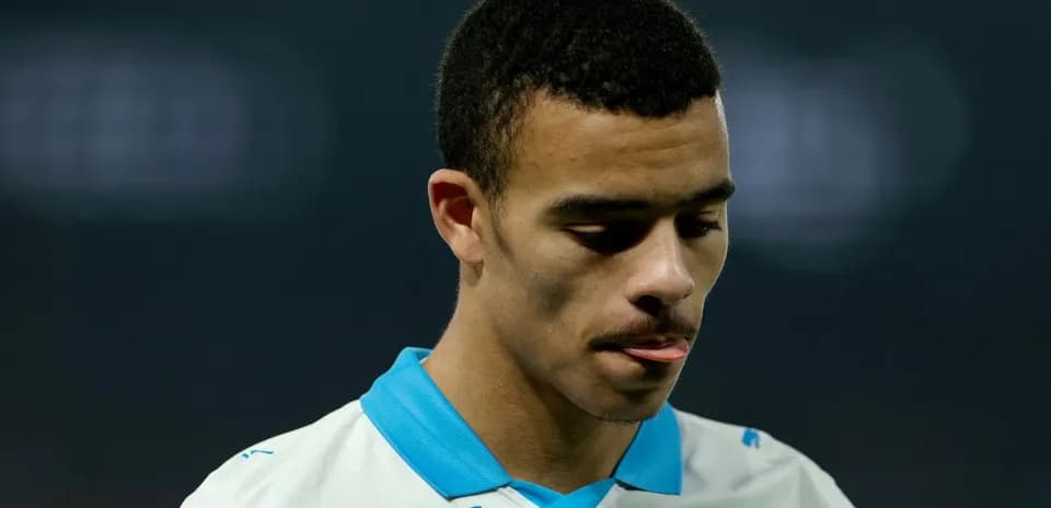 Player in Marseille jersey looking down during match