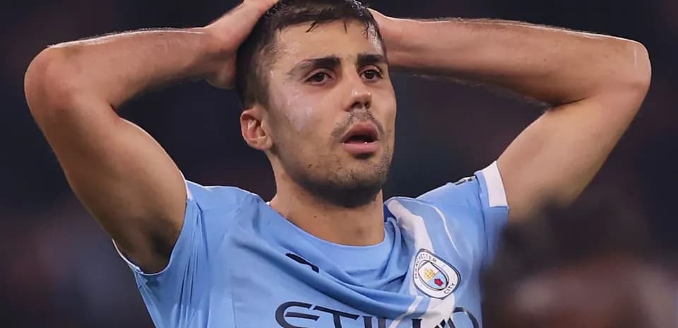Player in light blue jersey with hands on head