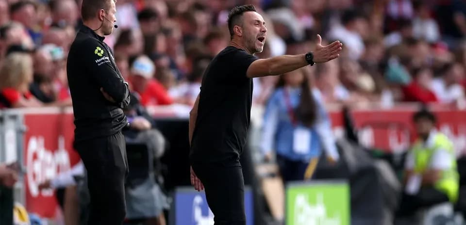 Coach gesturing on the sidelines during match