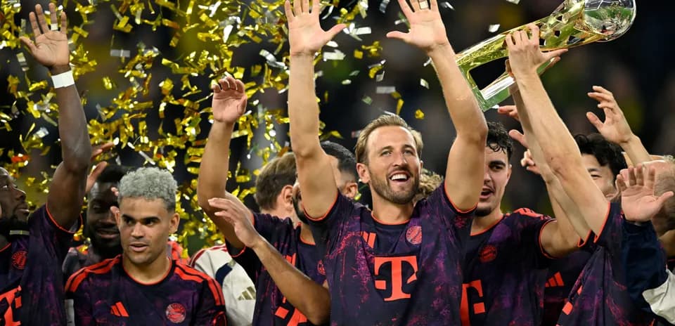 Bayern Munich players celebrating with trophy and confetti