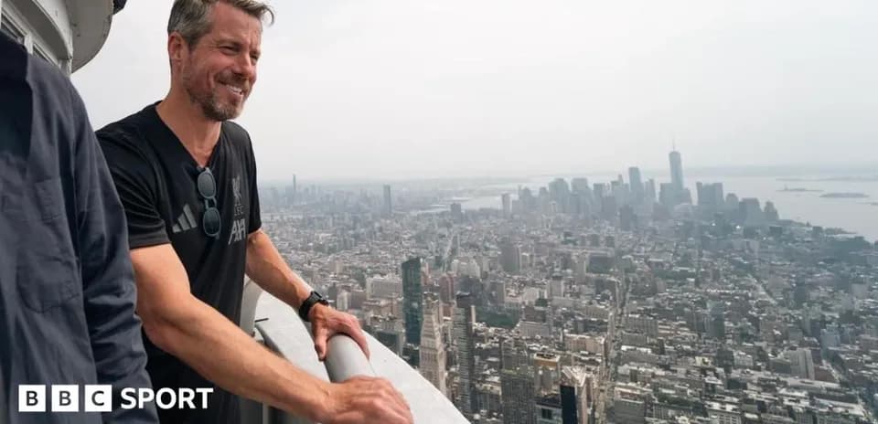 Person enjoying the view from a skyscraper rooftop
