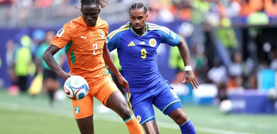 Ivorian player dribbling past opponent during match