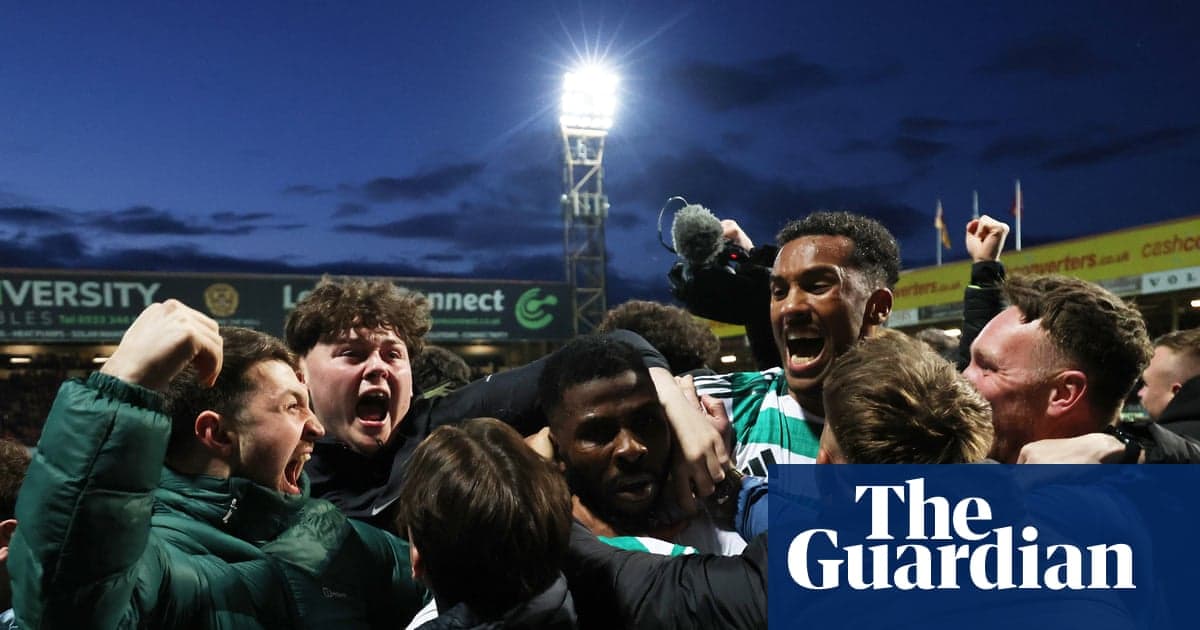Fans celebrating a goal at a football match