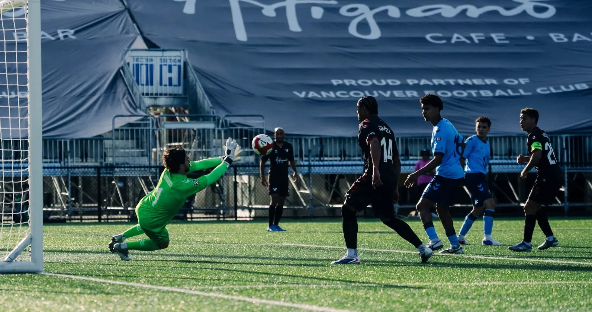Goalkeeper attempting to save a shot on goal