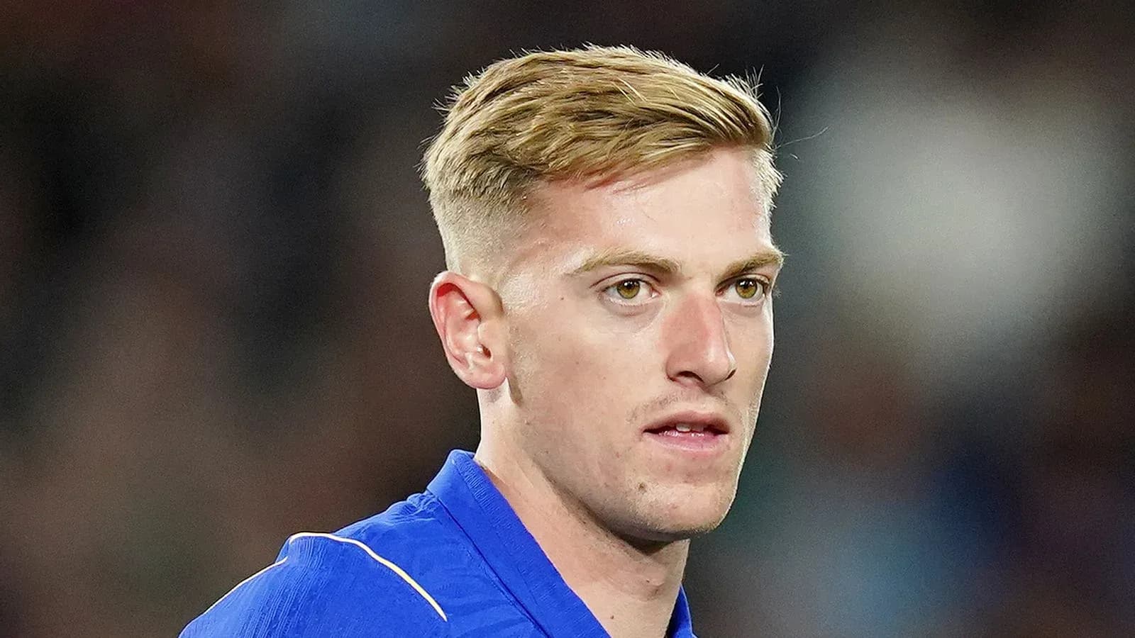 Football player in blue kit during match