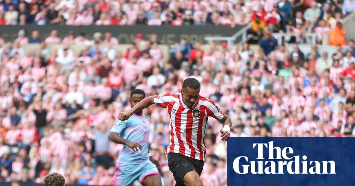 Player dribbling past opponent in crowded stadium