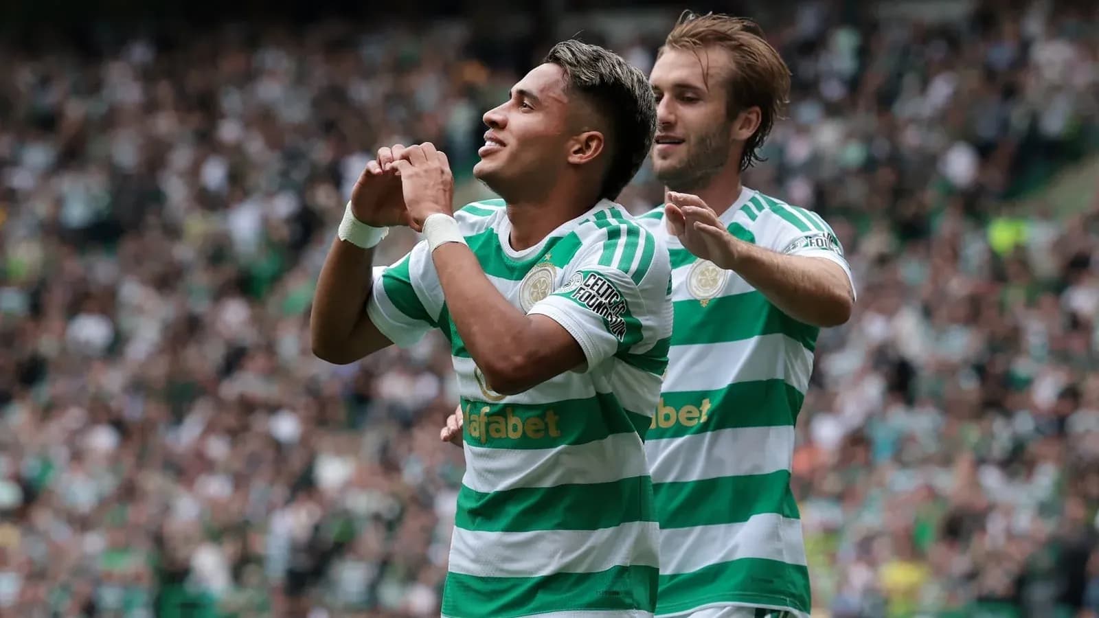 Celtic players celebrating a goal in stadium