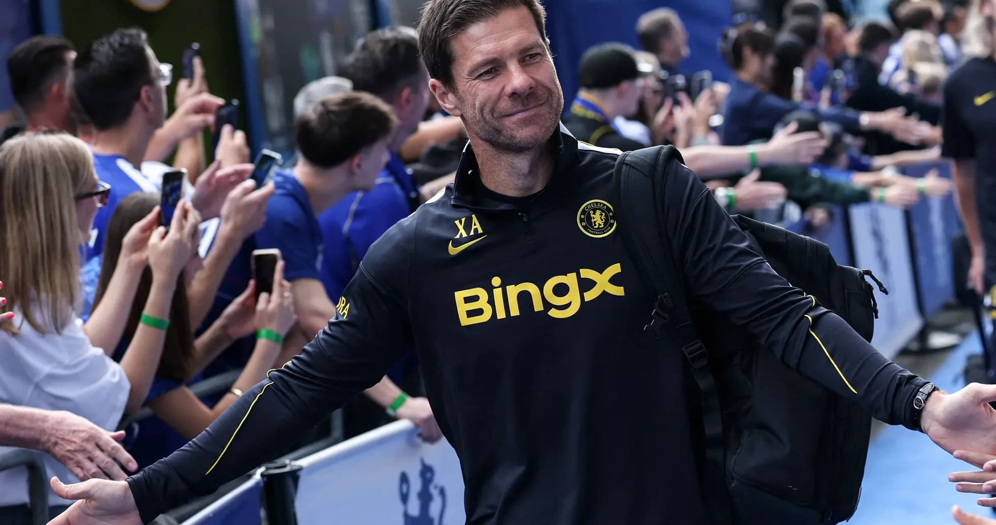Coach greeting fans outside the stadium entrance