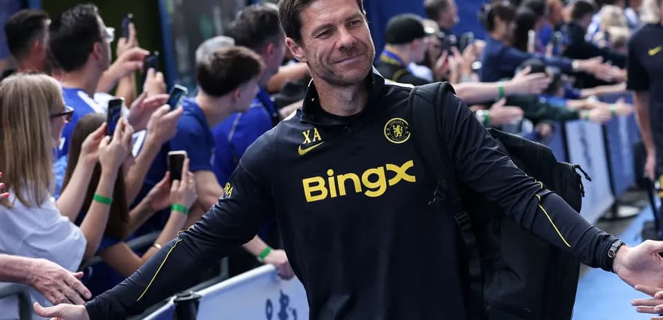 Coach greeting fans outside the stadium entrance