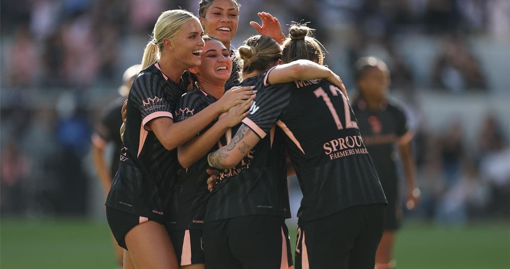 Celebration among Angel City players after a goal
