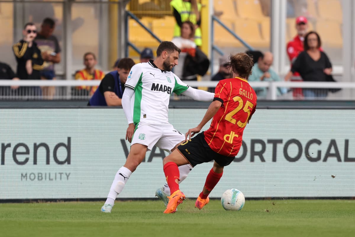 Sassuolo player challenging Lecce player during match
