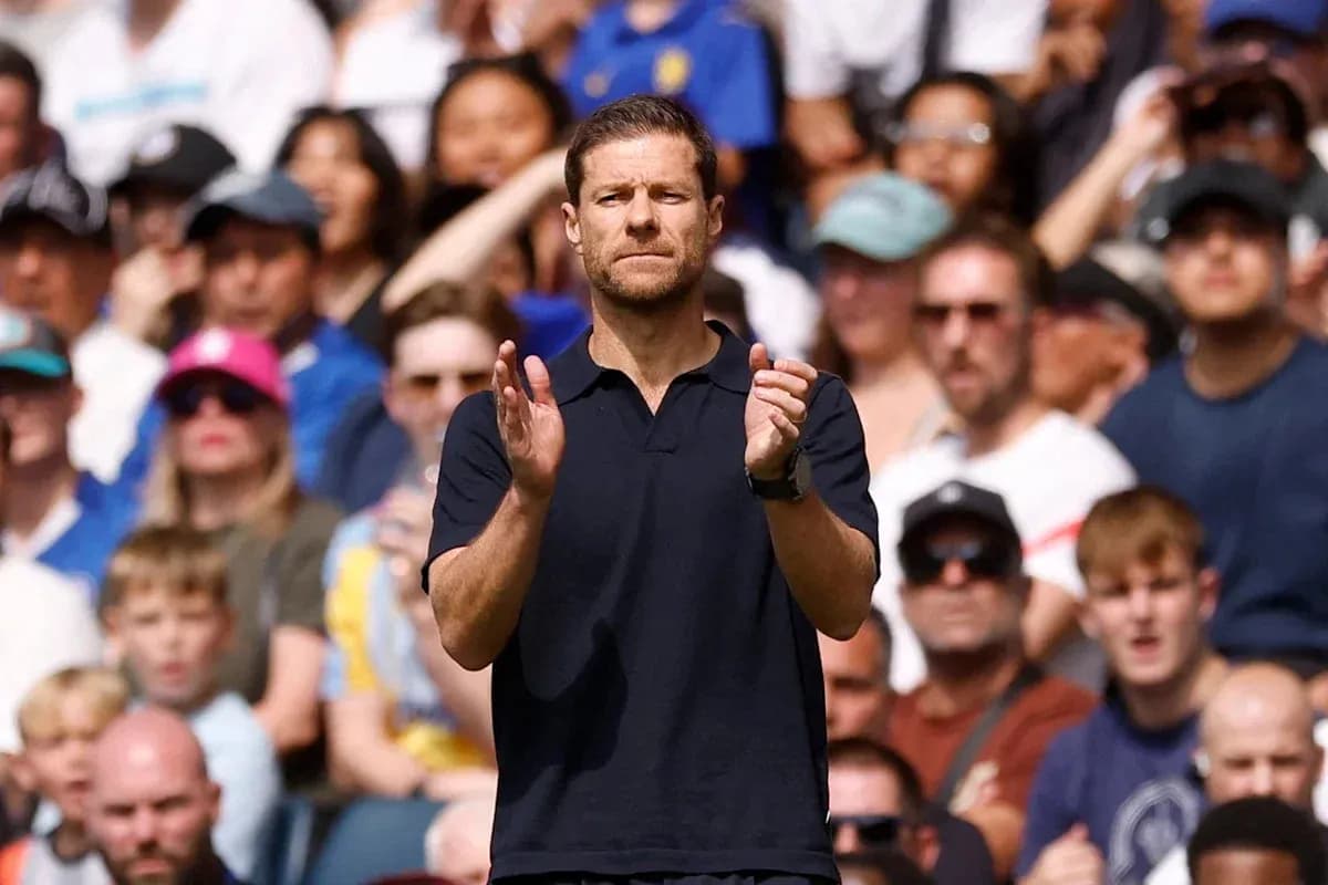 Coach applauding in front of cheering crowd