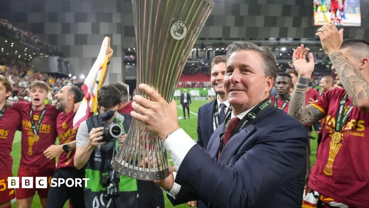 Manager celebrating with UEFA Europa League trophy