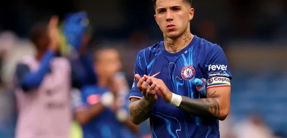 Player clapping in Chelsea kit during match