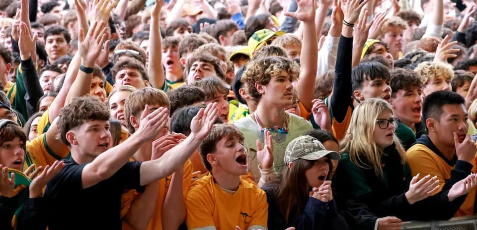 Crowd of fans cheering at a sports event