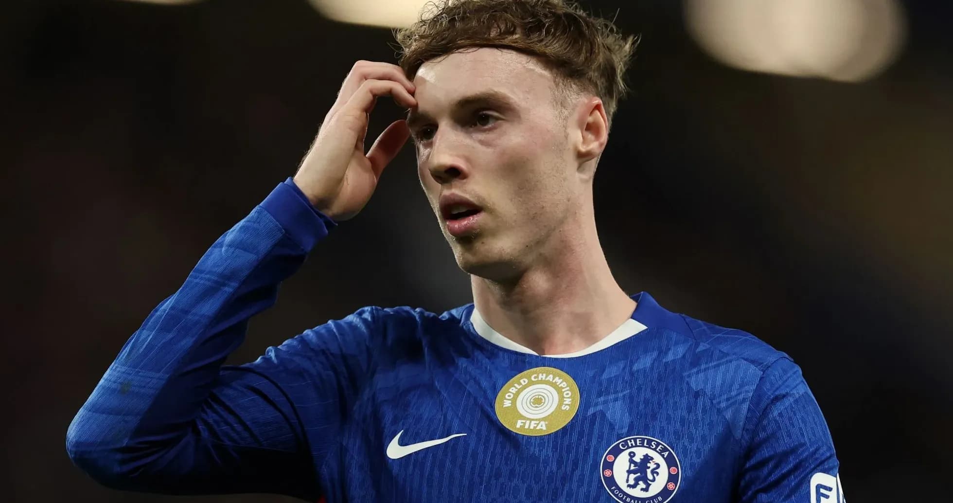 Chelsea player touching his head in confusion