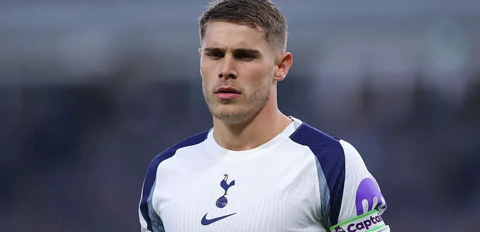 Player in Tottenham jersey with captain armband