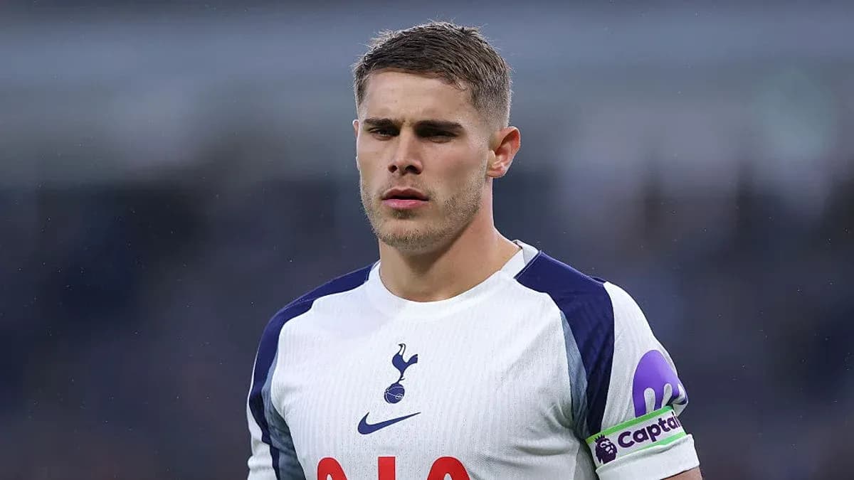 Player in Tottenham jersey with captain armband
