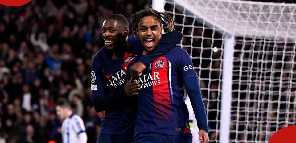 Two PSG players celebrating a goal on the pitch