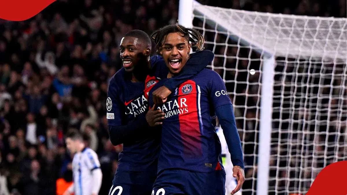 Two PSG players celebrating a goal on the pitch