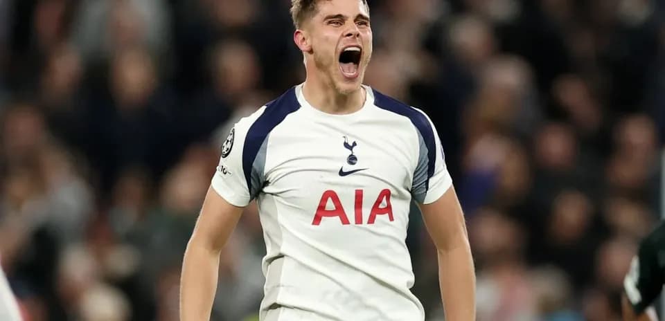 Player celebrating passionately in Tottenham jersey