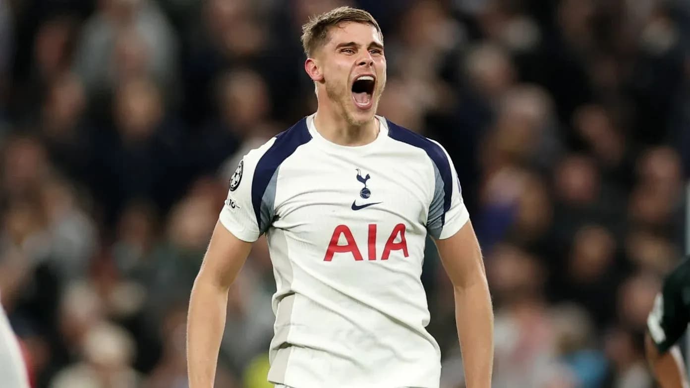 Player celebrating passionately in Tottenham jersey