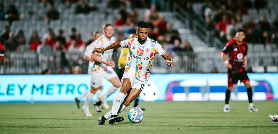 Player dribbling the ball during Phoenix Rising match