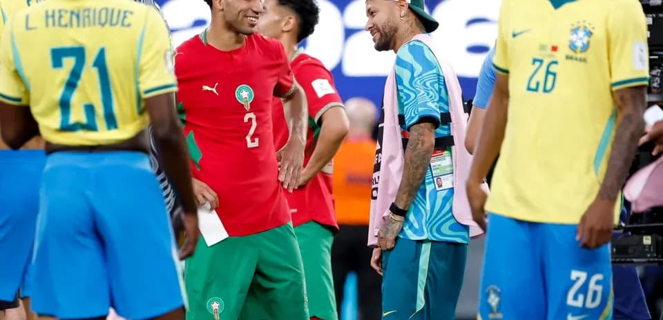 Players from Morocco and Brazil interacting on field
