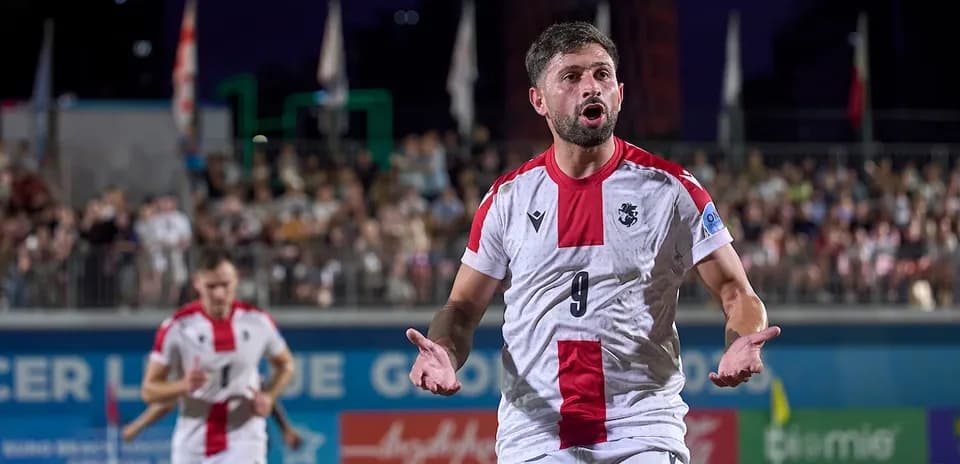 Player celebrating a goal during beach soccer match