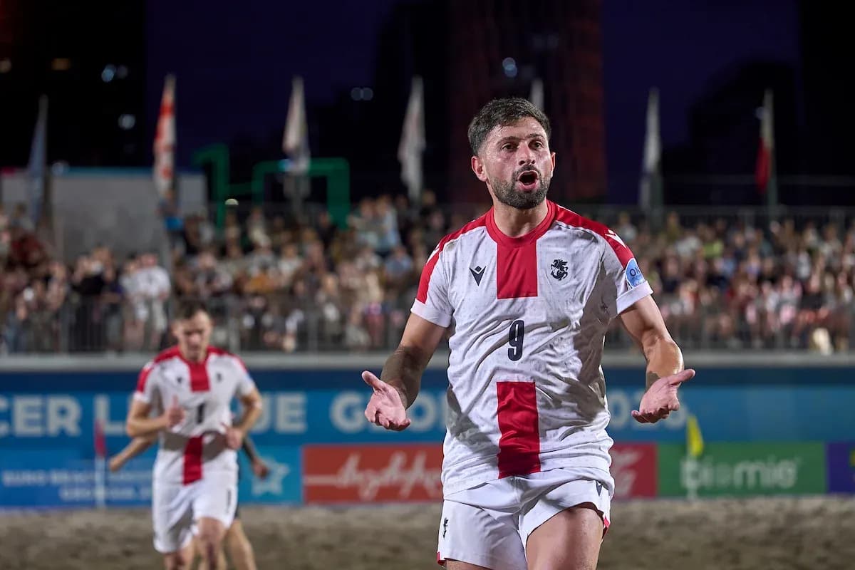 Player celebrating a goal during beach soccer match