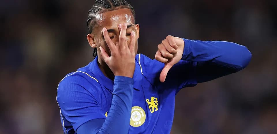 Player in blue jersey showing disapproval gesture