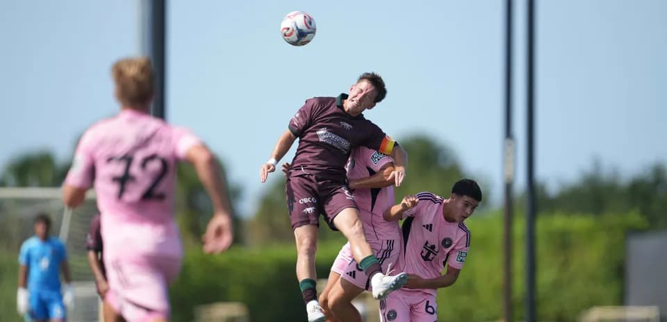 Players competing for the ball during match