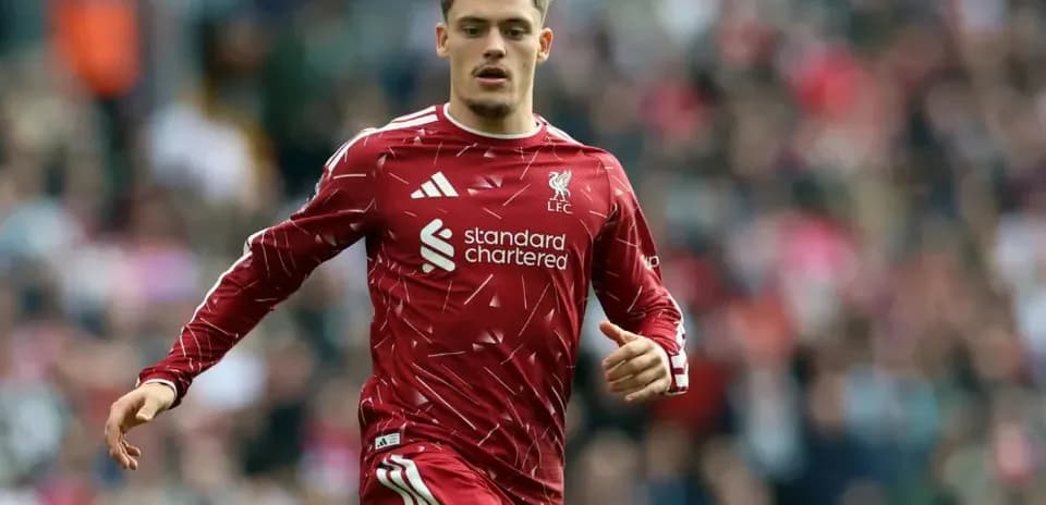 Player running on the pitch in Liverpool kit