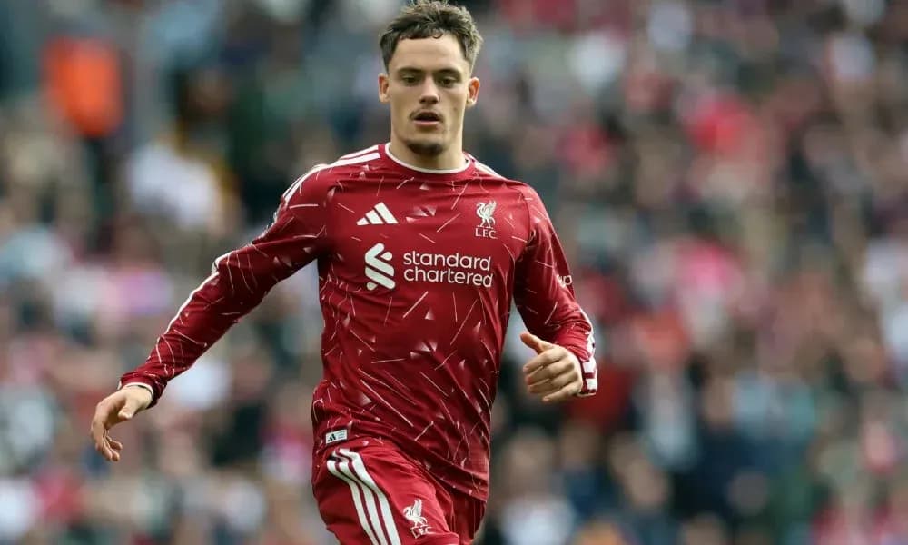Player running on the pitch in Liverpool kit