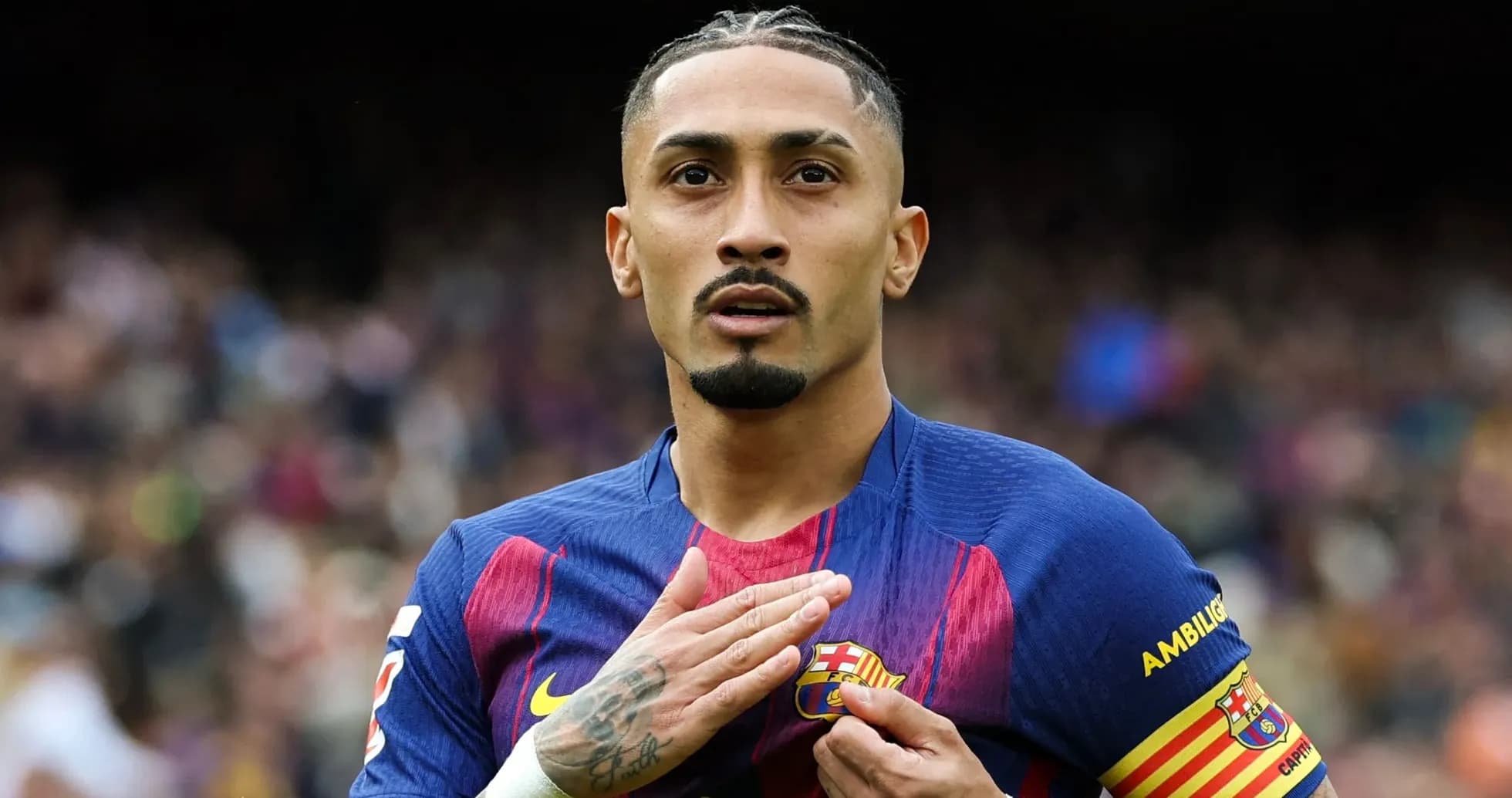 Player touching Barcelona crest during match