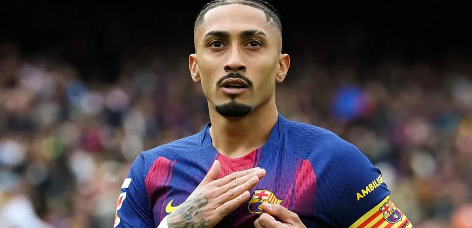 Player touching Barcelona crest during match