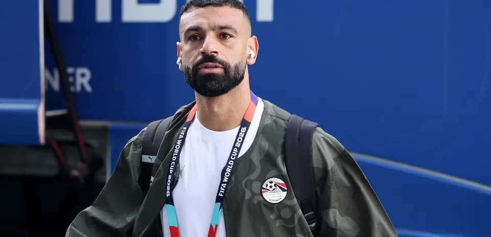 Player arriving at venue wearing headphones and jacket