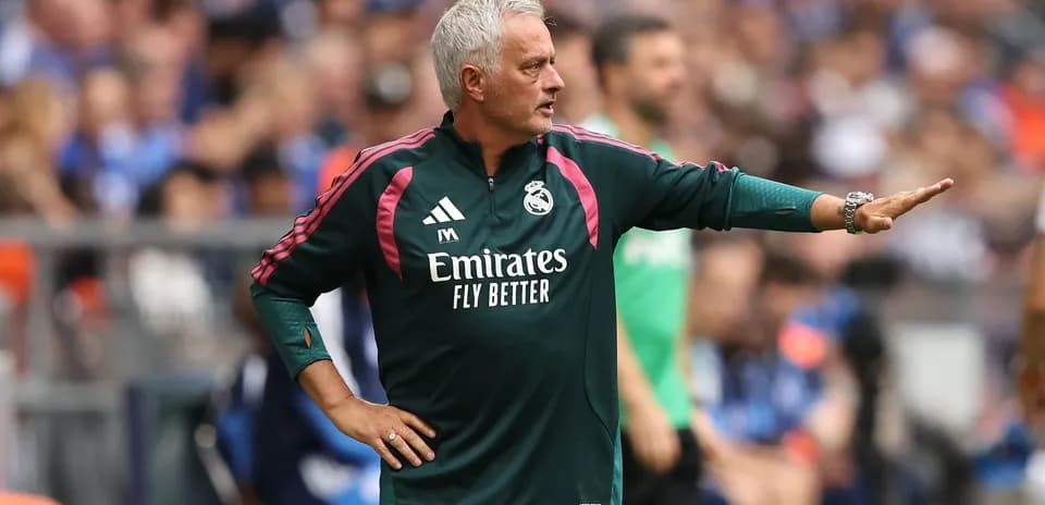 Manager directing players from the sideline during match