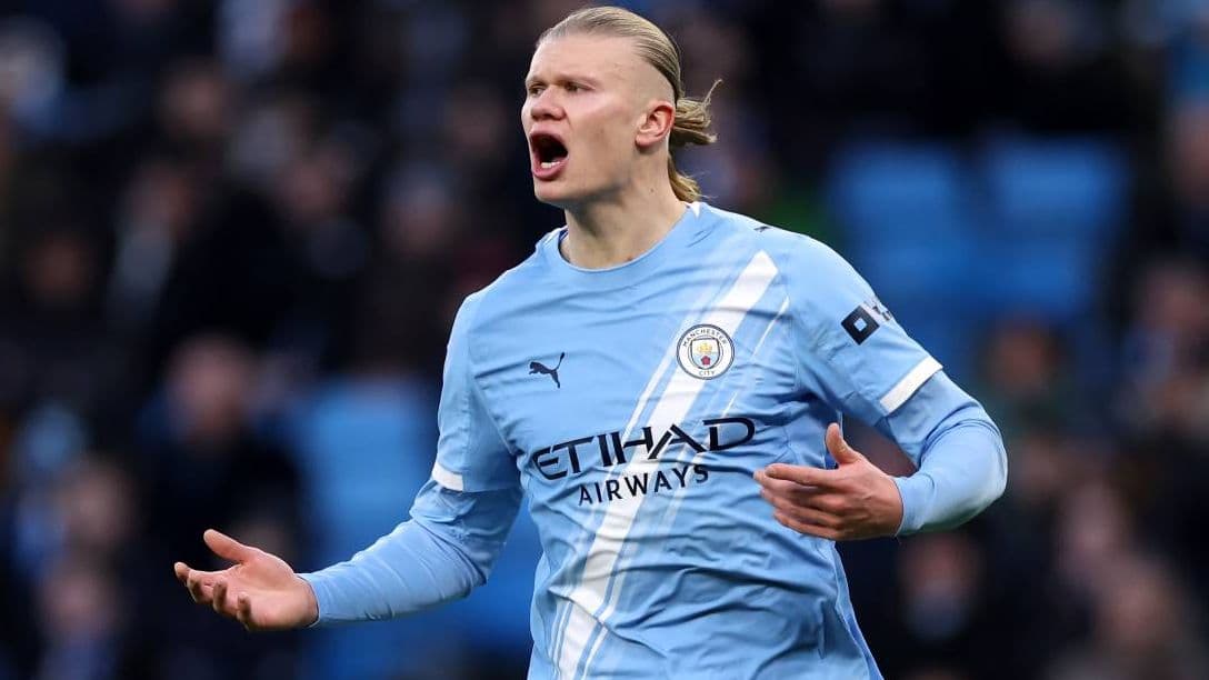Player celebrating a goal in Manchester City kit