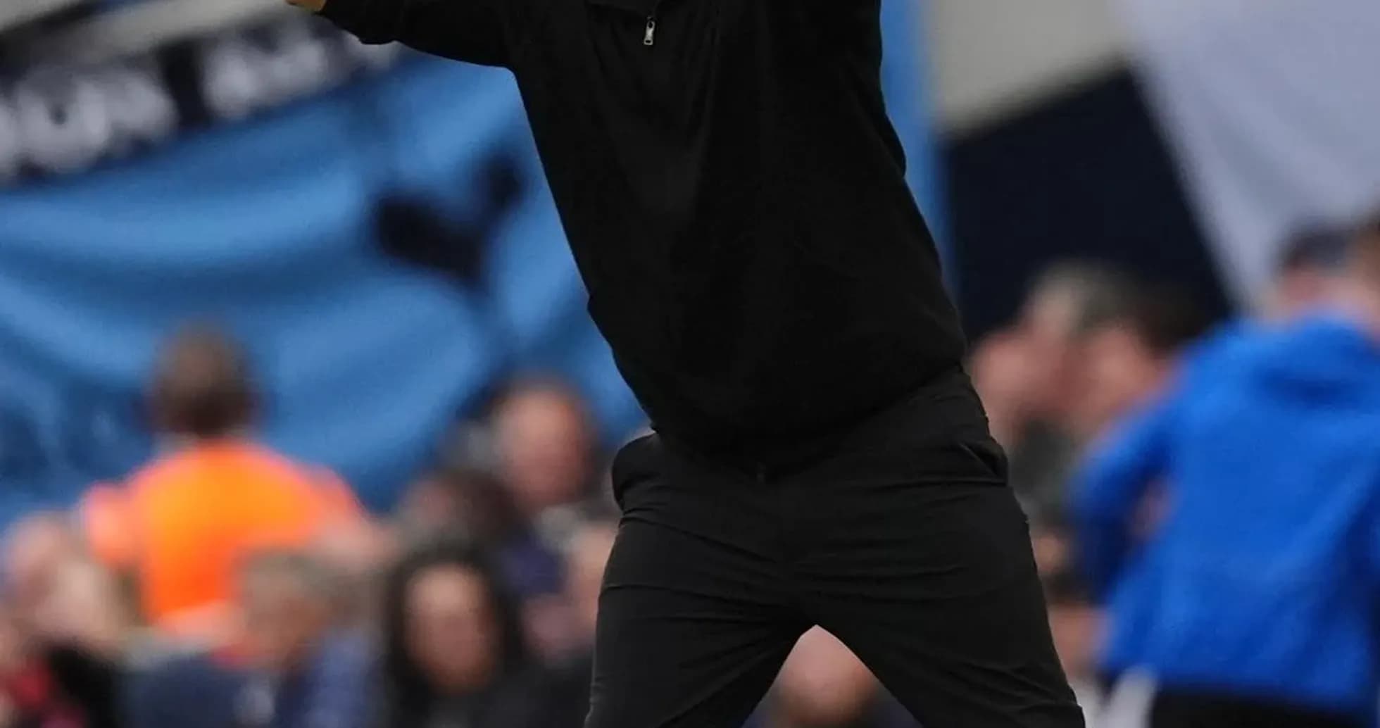 Coach gesturing from the sideline during match