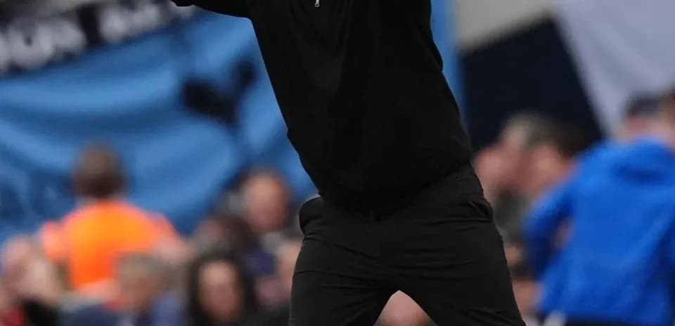 Coach gesturing from the sideline during match