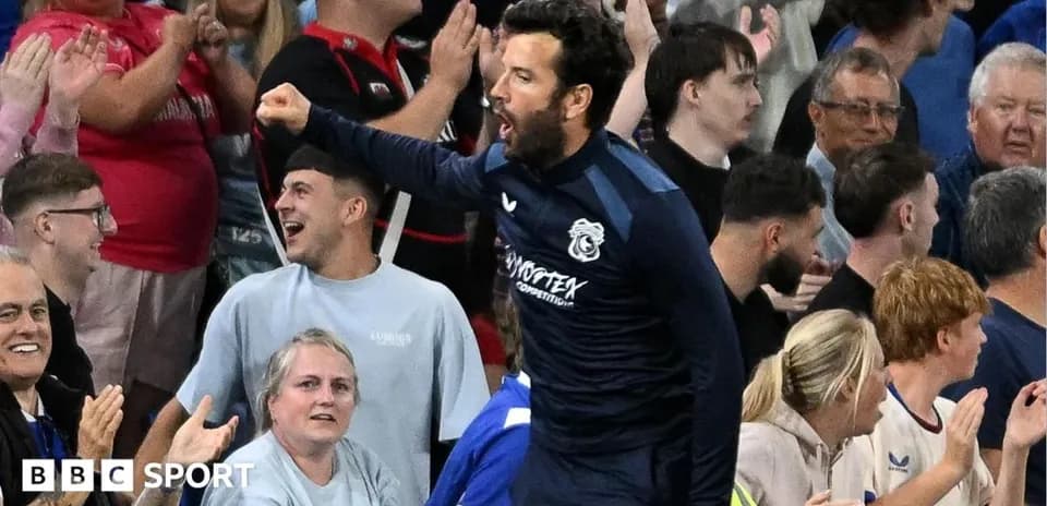 Player celebrating with fans in stadium stands