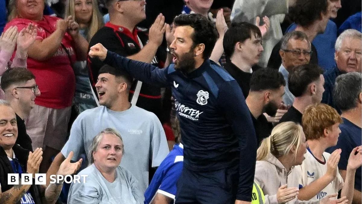 Player celebrating with fans in stadium stands